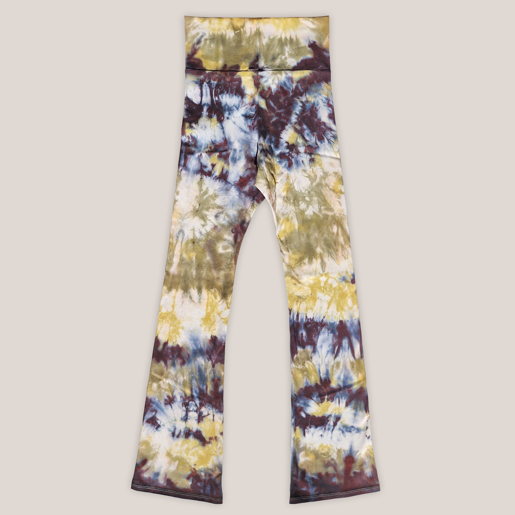 Tie-dye leggings with a multicolor pattern on a beige background