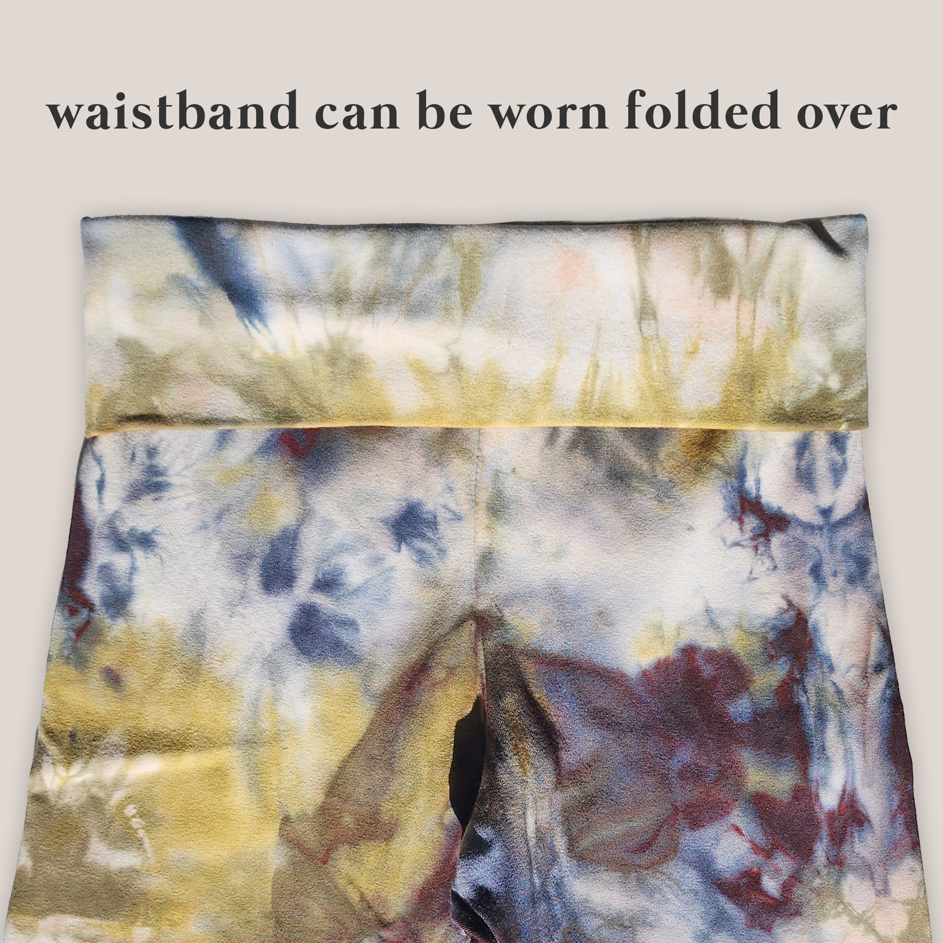 Multicolored tie-dye waistband with text indicating it can be worn folded over.