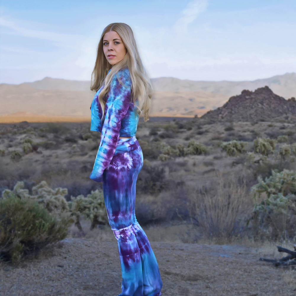 Woman wearing a pair of tie dye yoga pants and hoodie crop top by Akasha Sun