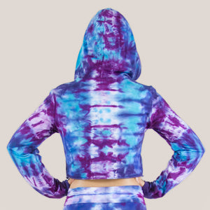 Woman wearing a purple and blue tie dye crop top hoodie by Akasha Sun.