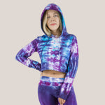 Woman wearing a purple and blue tie dye crop top hoodie by Akasha Sun.