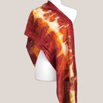 A rust orange tie dye scarf with fringe by Akasha Sun