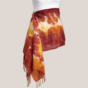 A rust orange tie dye scarf with fringe by Akasha Sun