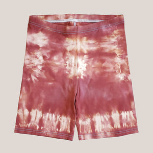 A pair of rust tie dye bike shorts by Akasha Sun