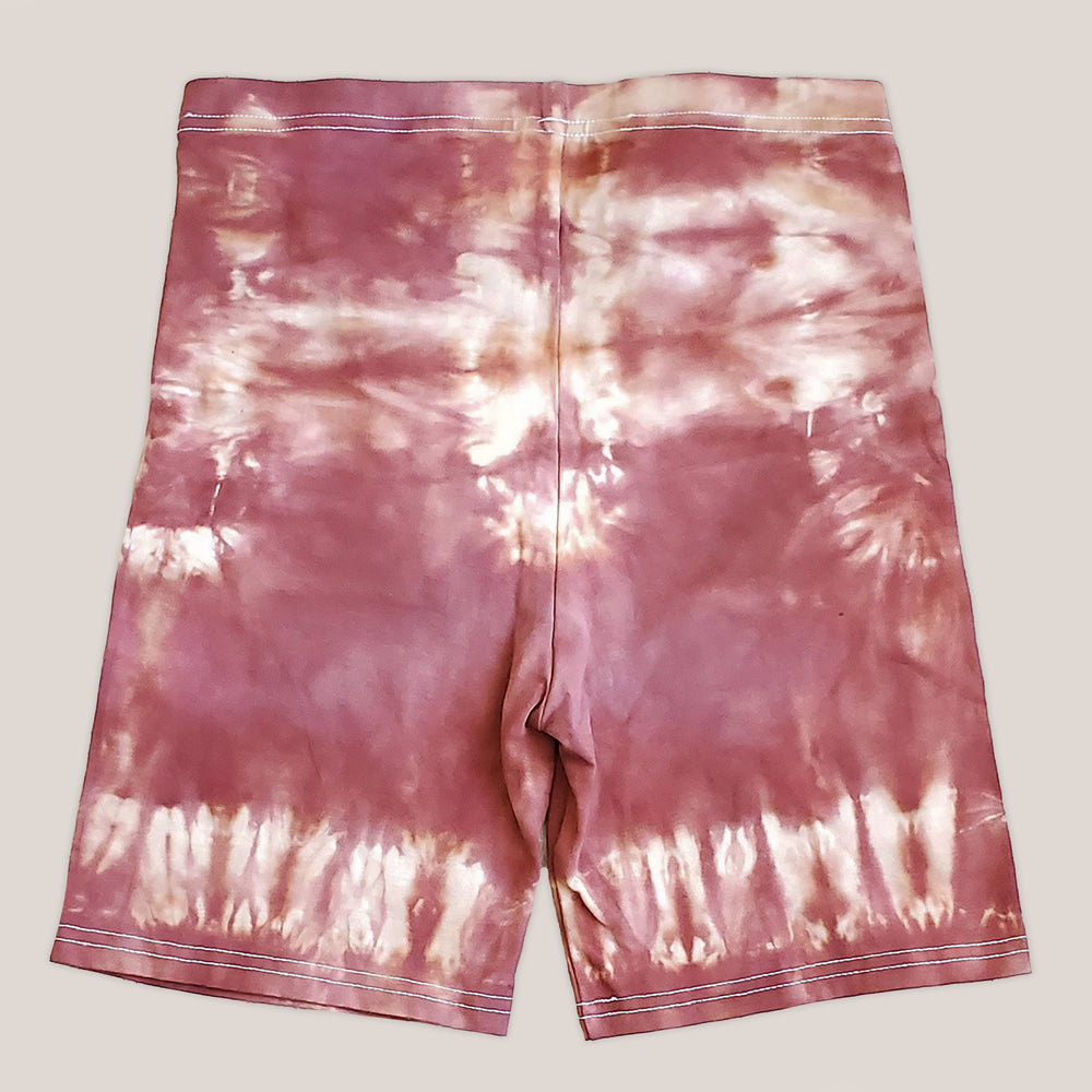 A pair of rust tie dye bike shorts by Akasha Sun