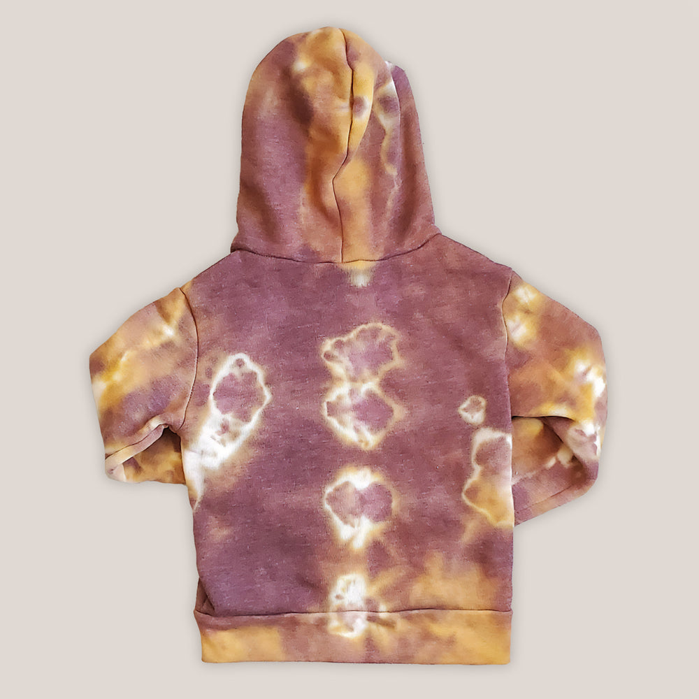 A rust tie dye children's jacket with fleece lining, pockets, and hood.