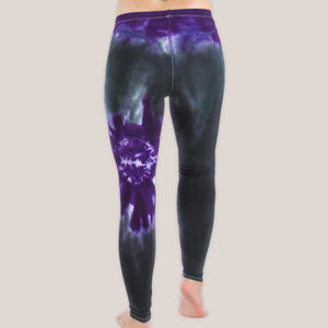 Woman wearing a pair of Akasha Sun purple chakra tie dye leggings made of sustainable cotton.