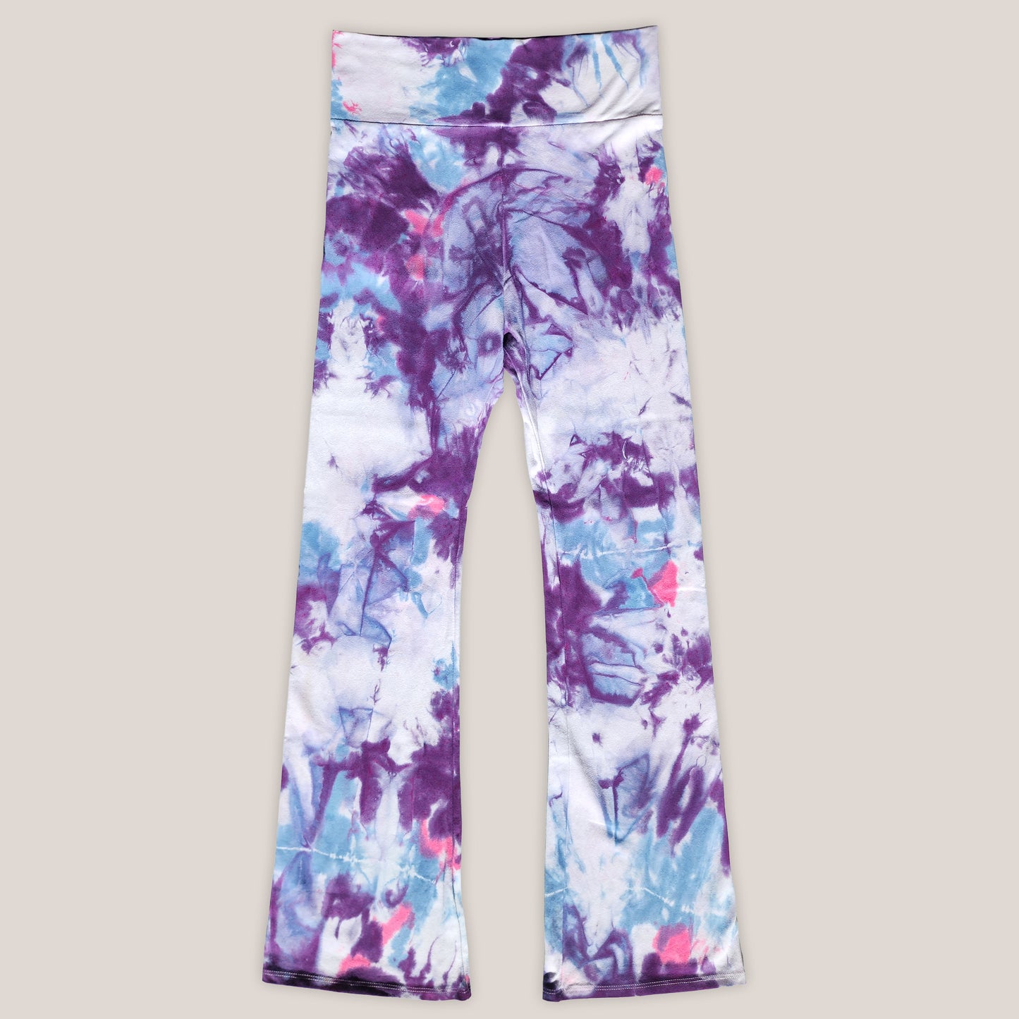 Tie-dye leggings with purple and blue patterns on a light gray background