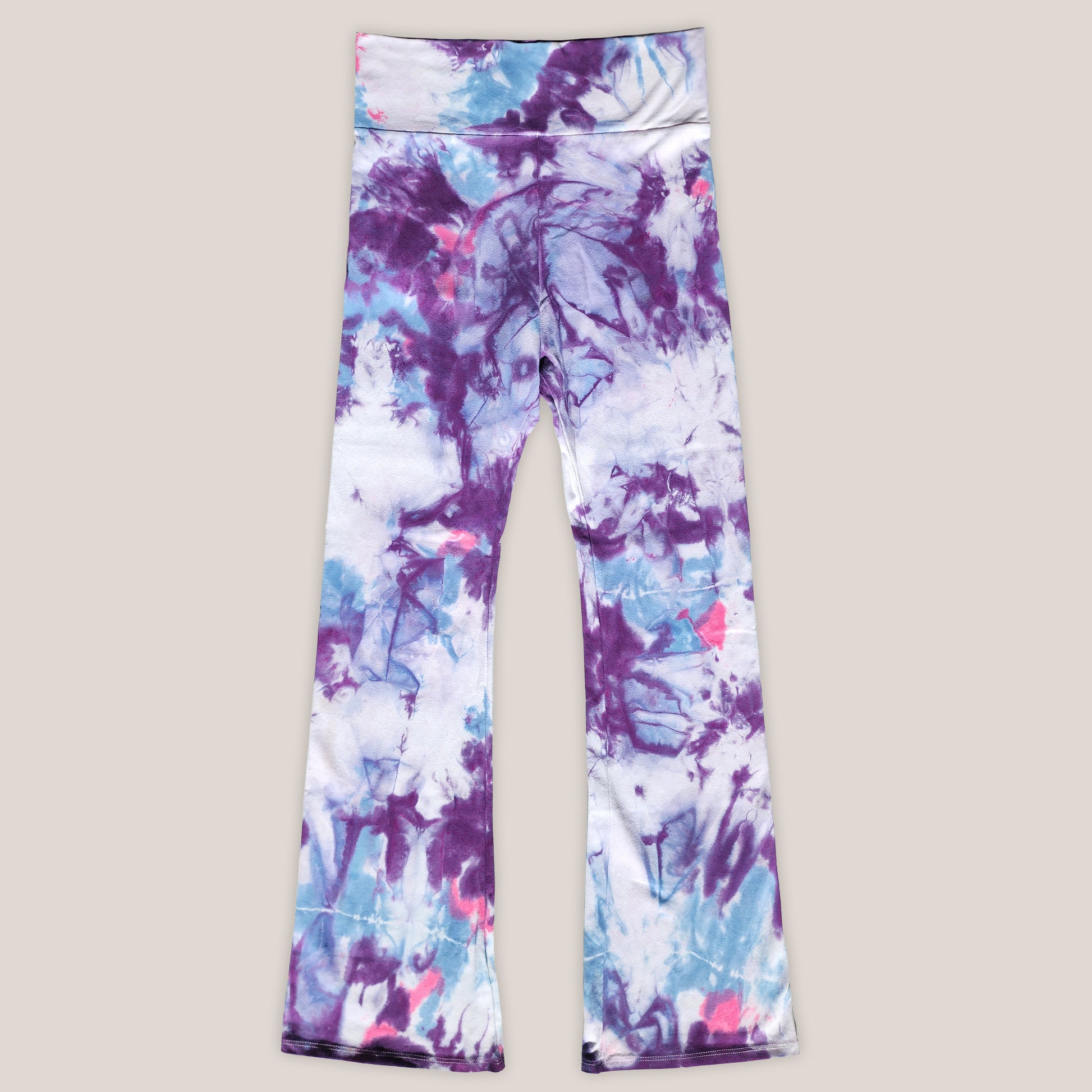 Tie-dye leggings with purple and blue patterns on a light gray background