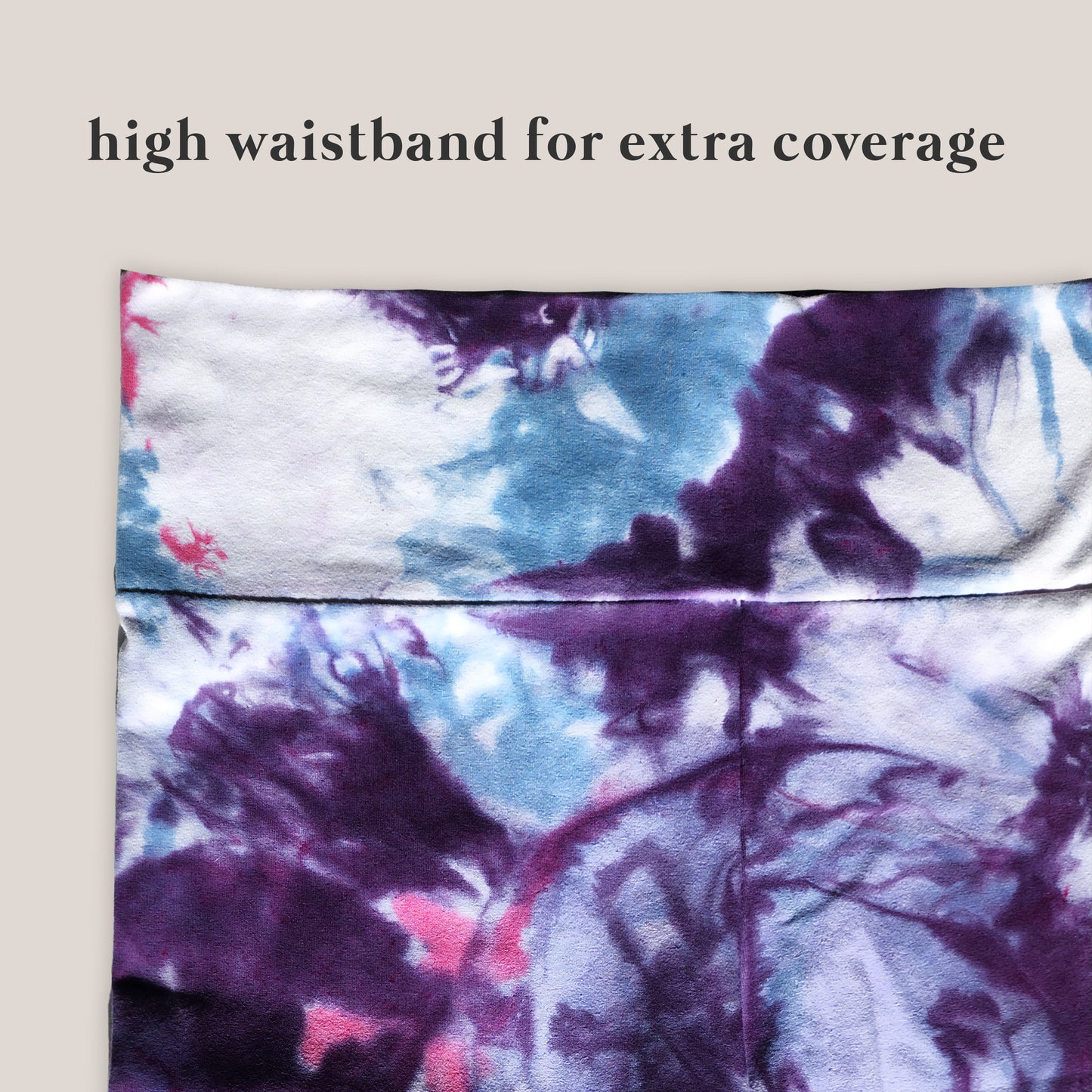 Tie-dye patterned pants with a high waistband for extra coverage on a beige background.