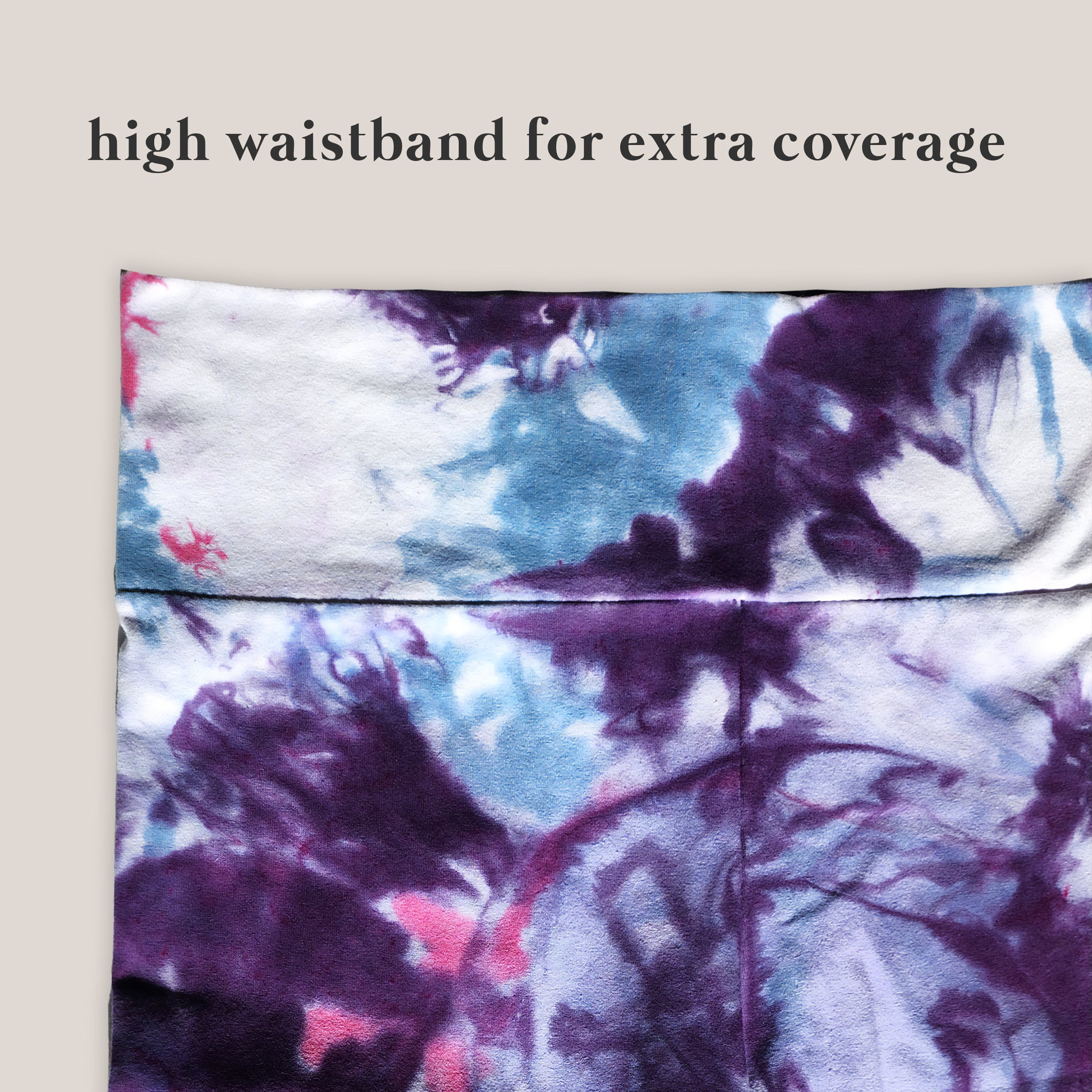 Tie-dye patterned pants with a high waistband for extra coverage on a beige background.