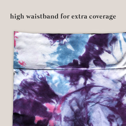 Tie-dye patterned pants with a high waistband for extra coverage on a beige background.