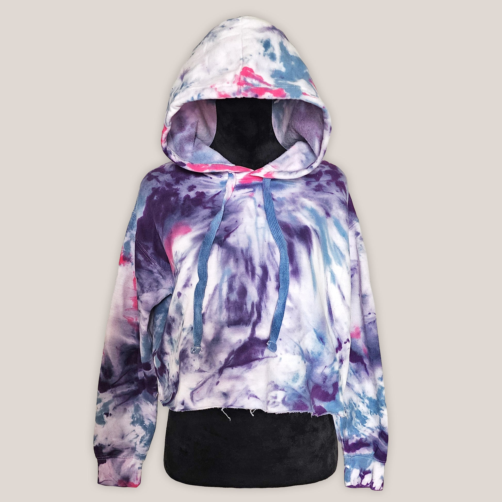 Multicolored tie-dye hoodie on a light gray background