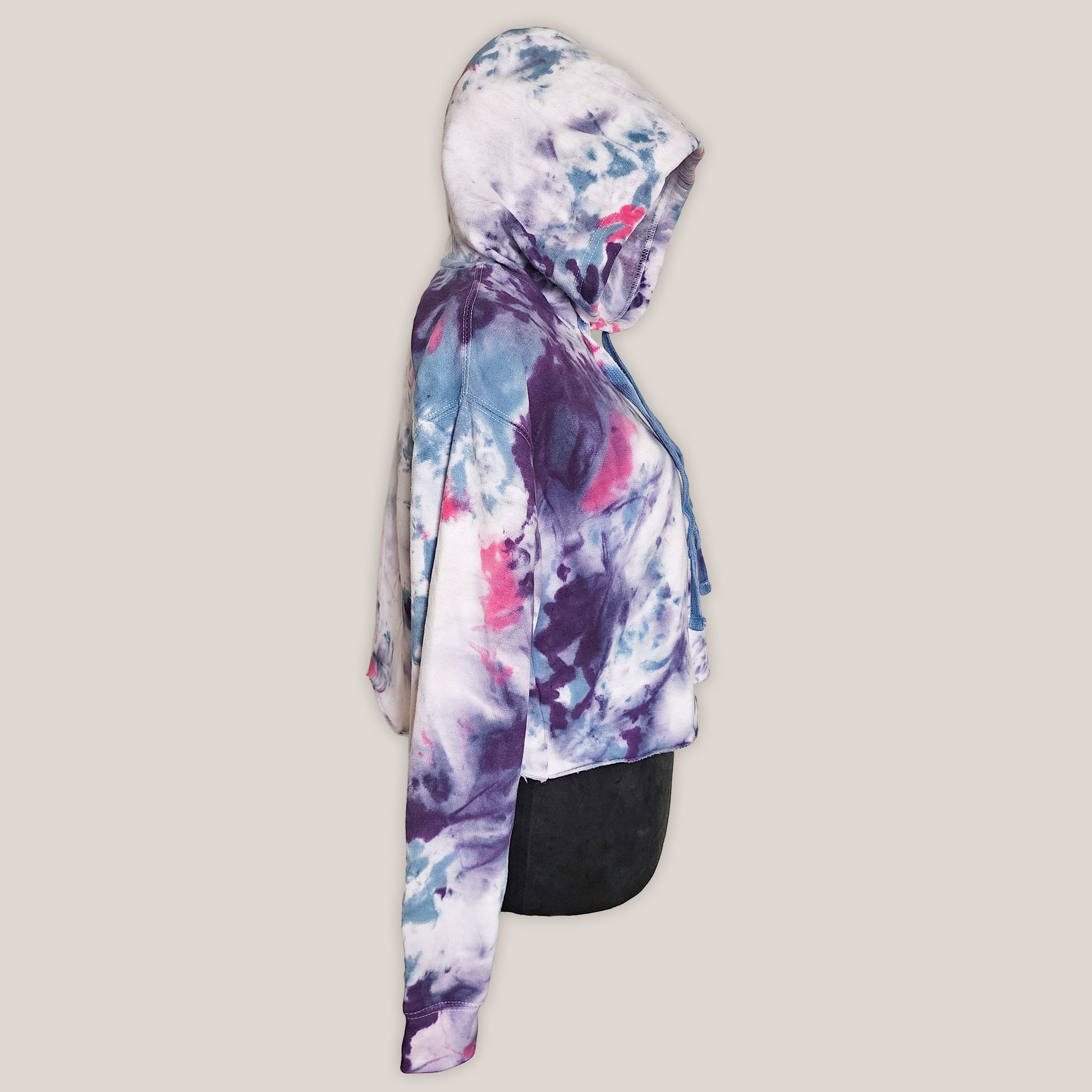 Hoodie with a tie dye design on a beige background