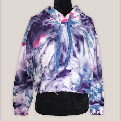Multicolored tie-dye hoodie on a mannequin against a plain background
