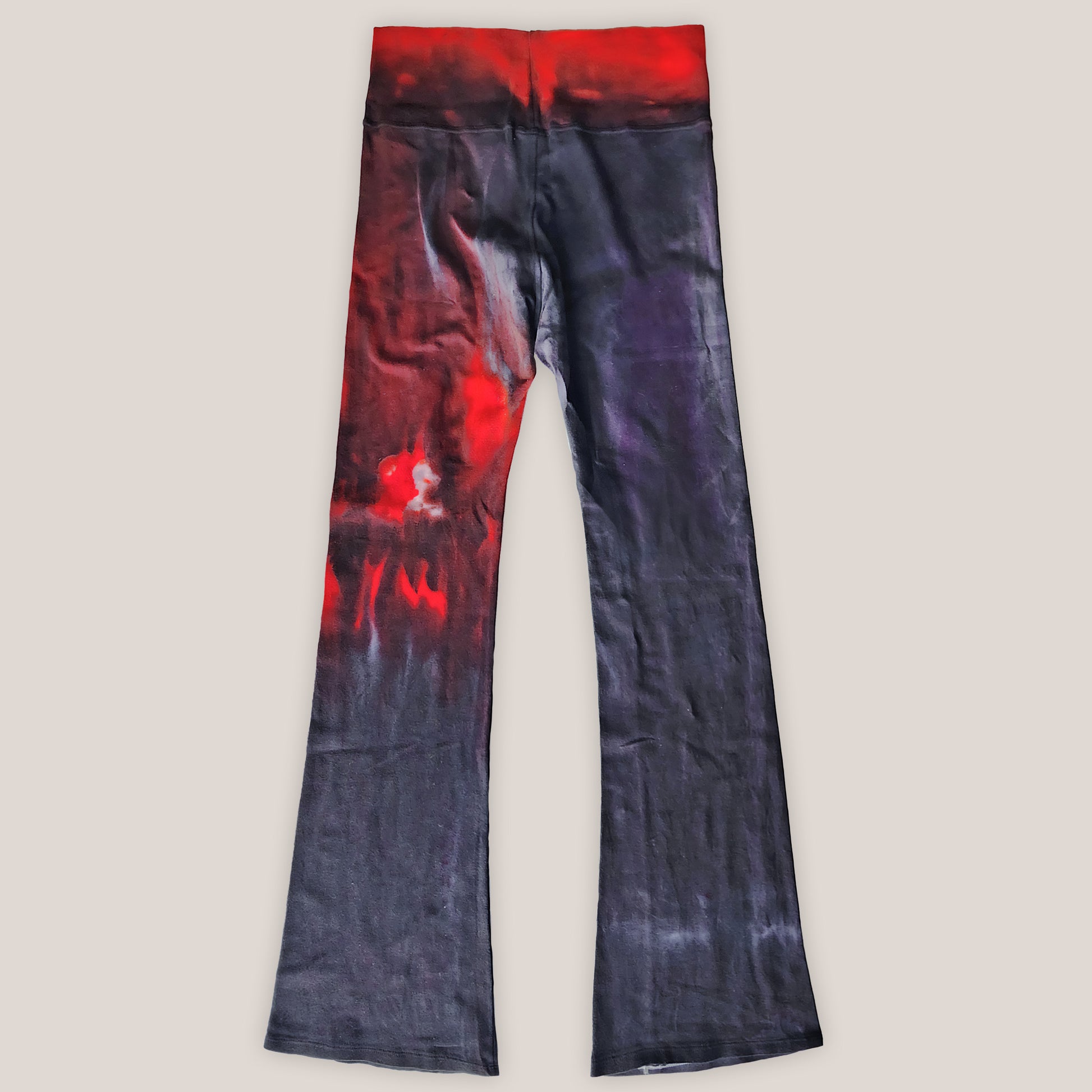 Black and red tie-dye pants on a beige background