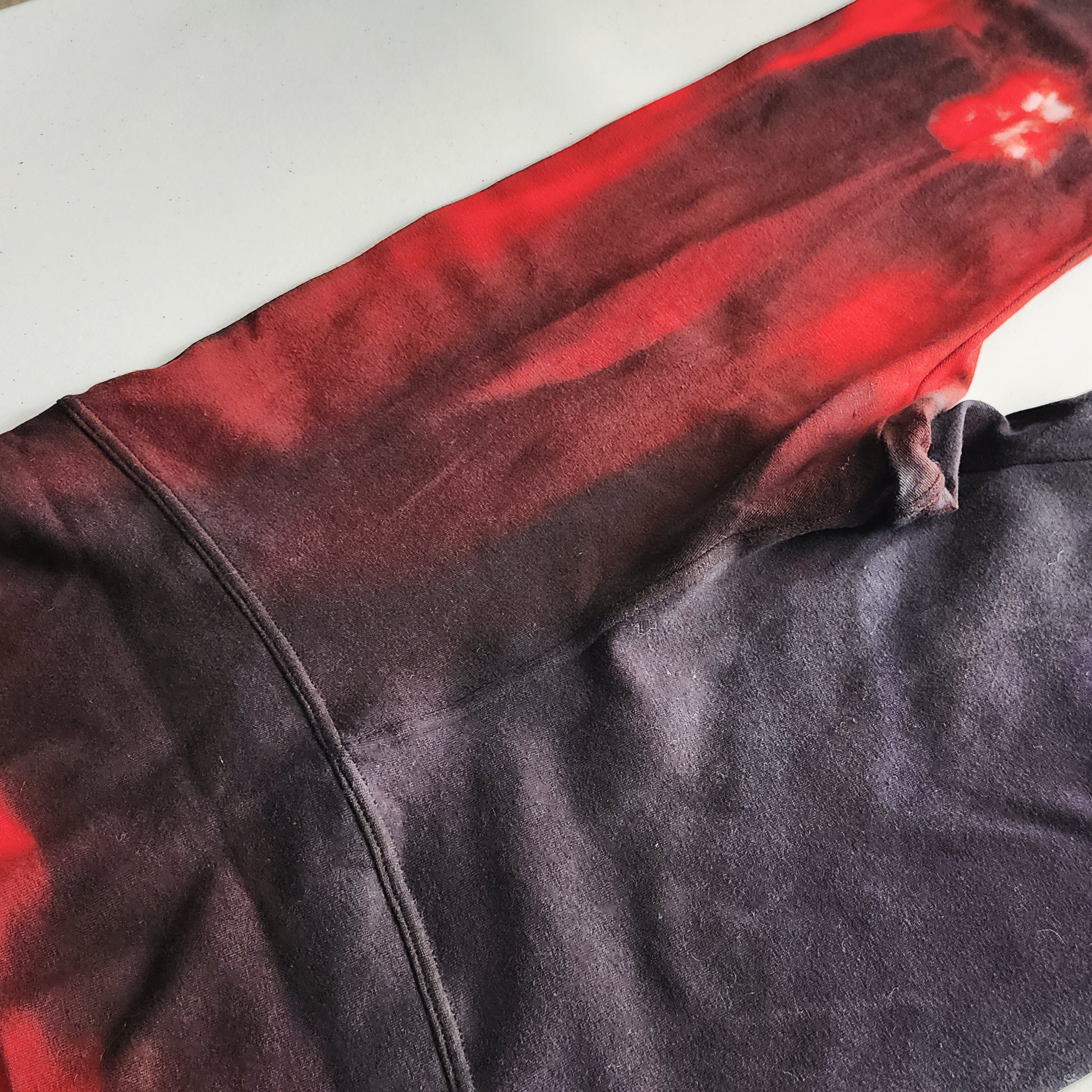 Close-up of a dark fabric with red accents on a white background