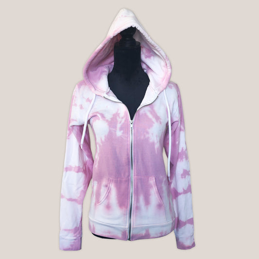 Pink and white tie-dye hoodie on a beige background