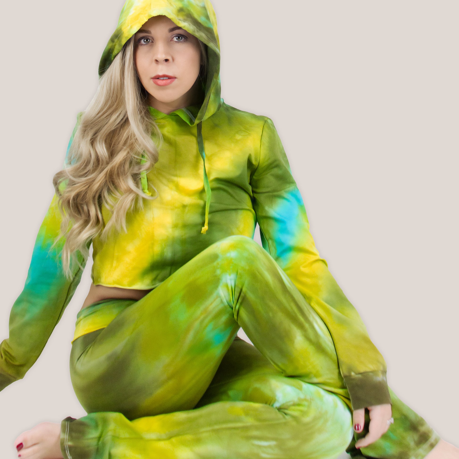 Woman wearing a pair of green tie dye yoga pants with a fold over waistband by Akasha Sun.