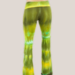 Woman wearing a pair of green tie dye yoga pants with a fold over waistband by Akasha Sun.