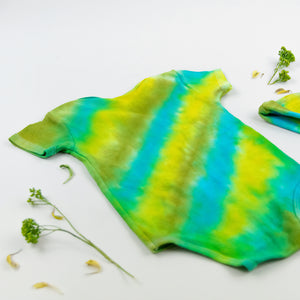 Green and blue tie dye organic cotton baby bodysuit and hat set by Akasha Sun.