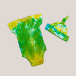 Green, yellow, and blue tie dye organic cotton baby bodysuit and hat set by Akasha Sun.