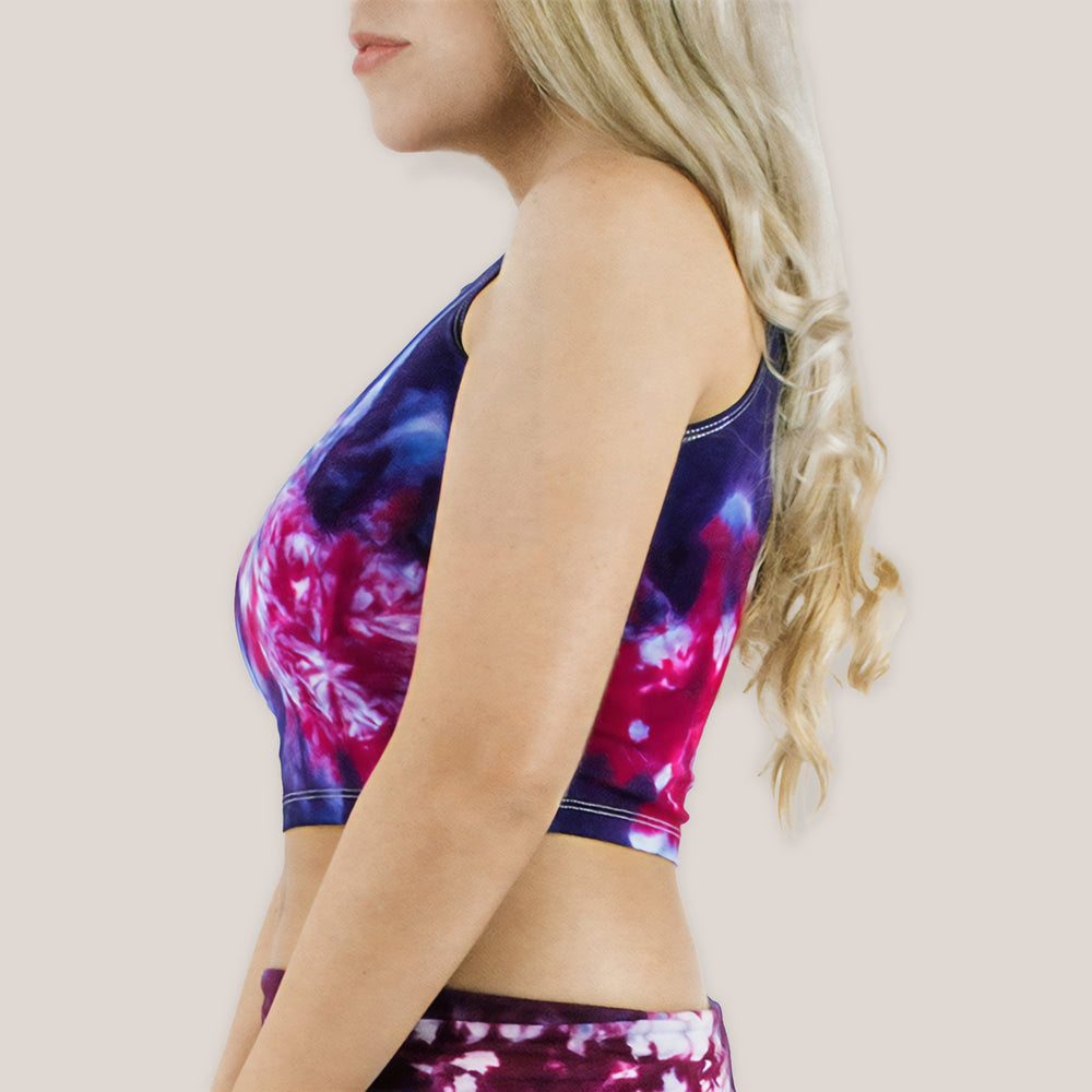 Woman wearing a purple and pink tie dye crop top by Akasha Sun.