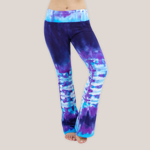 Woman wearing a pair of purple and blue tie dye sustainable yoga pants by Akasha Sun.