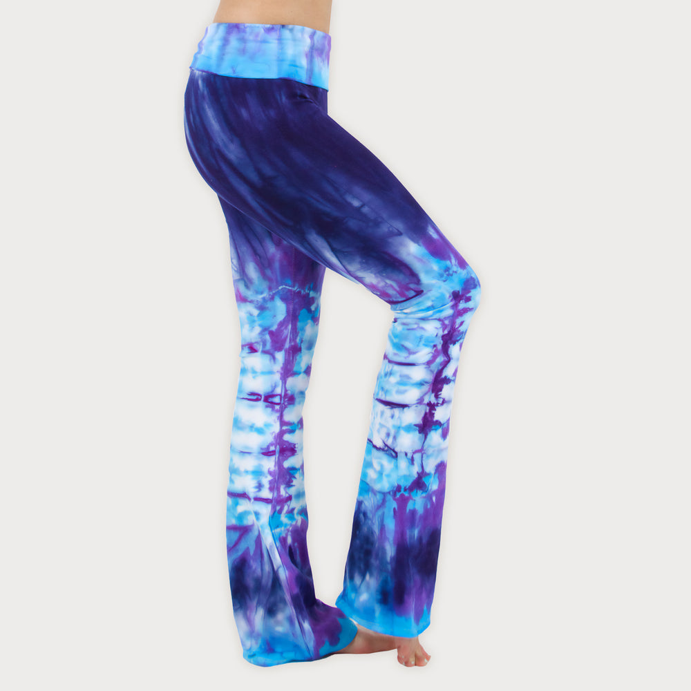 Woman wearing a pair of purple and blue tie dye sustainable yoga pants by Akasha Sun.