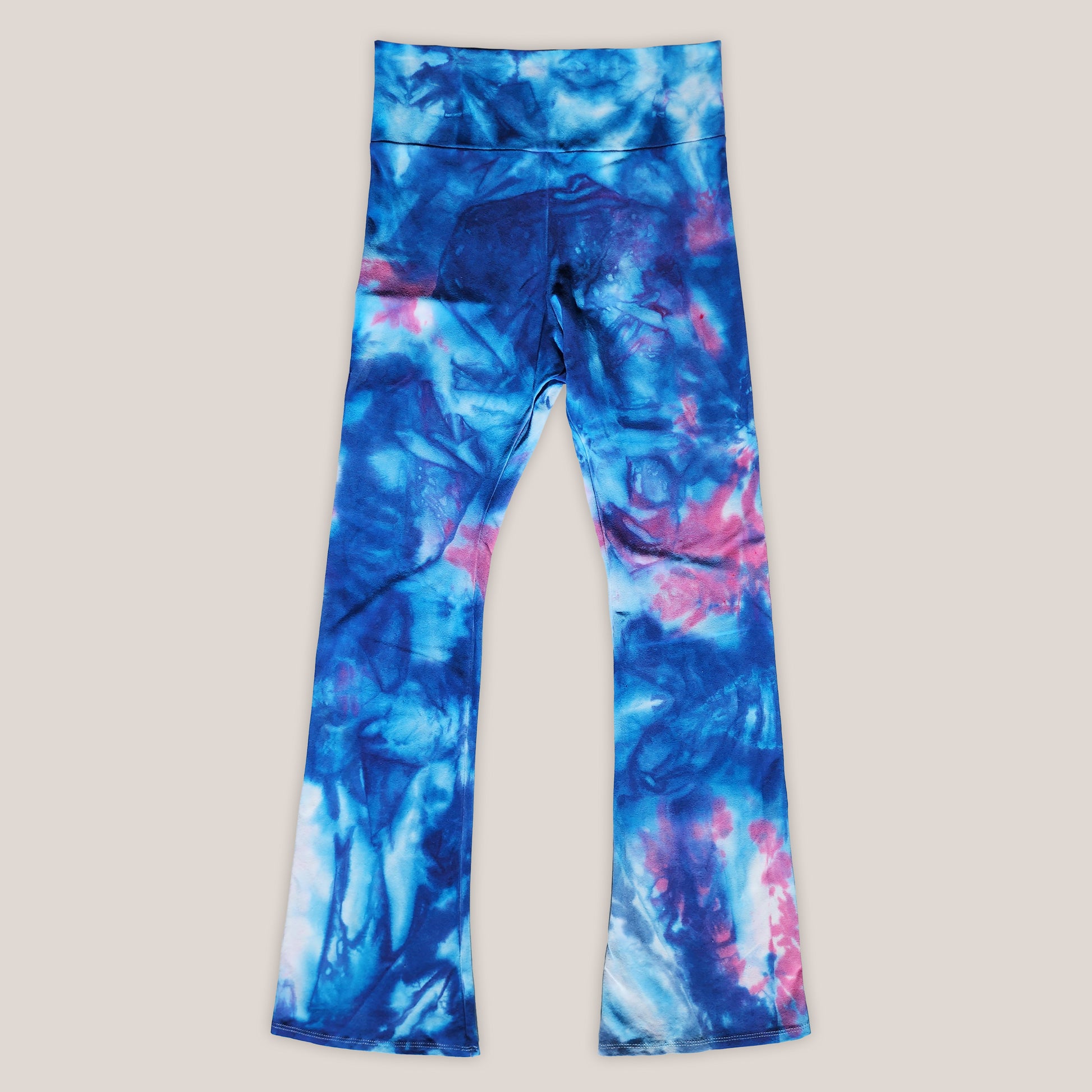 Blue and pink tie-dye leggings on a beige background