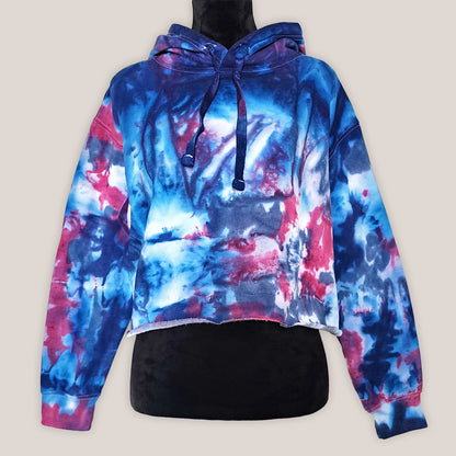 Tie-dye hoodie with blue and pink patterns on a beige background