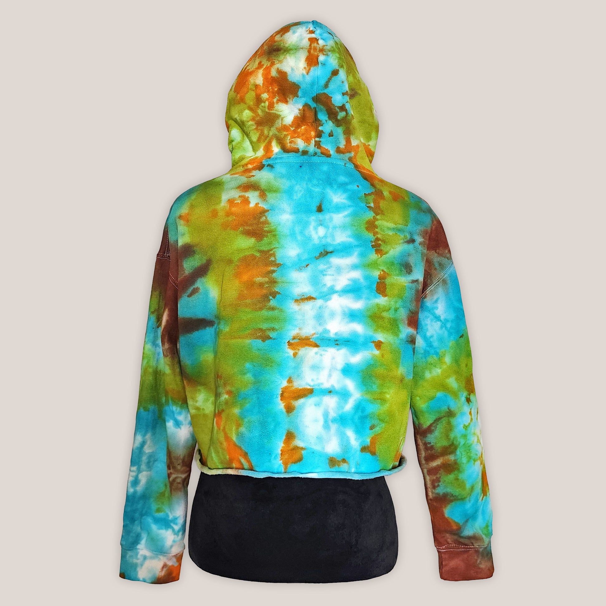 Tie-dye hoodie with a colorful pattern on a beige background