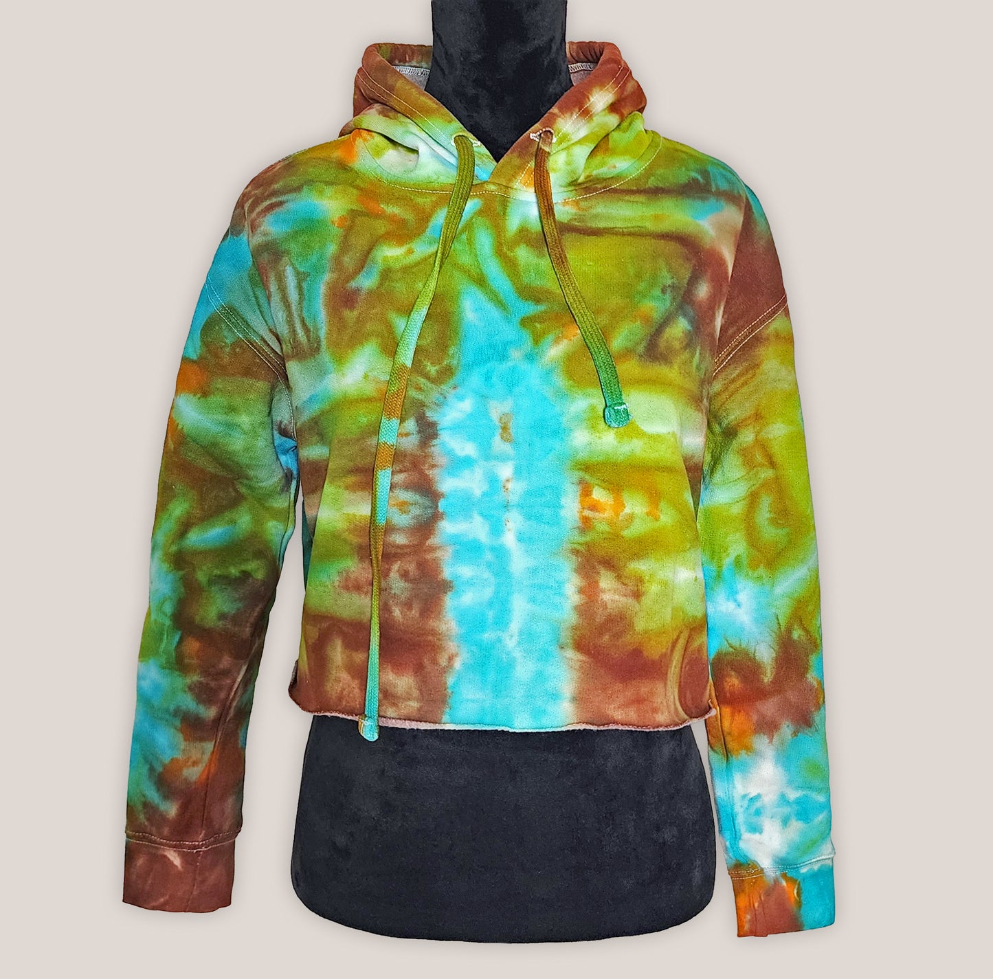 Colorful tie-dye hoodie on a mannequin against a plain background