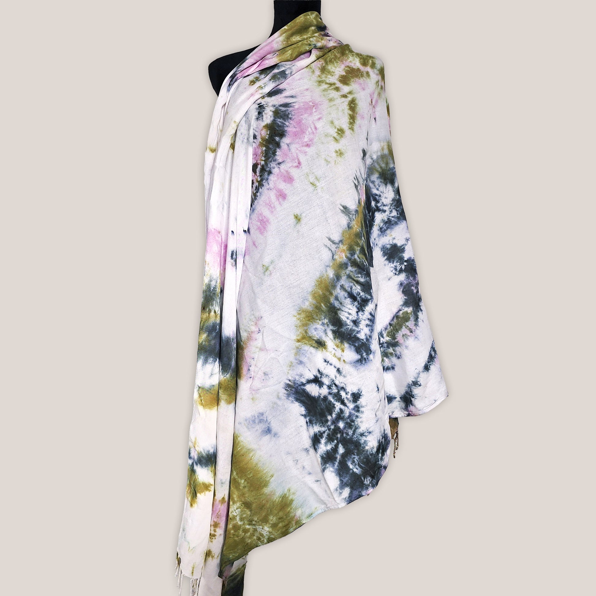 Colorful tie-dye scarf on a mannequin against a plain background