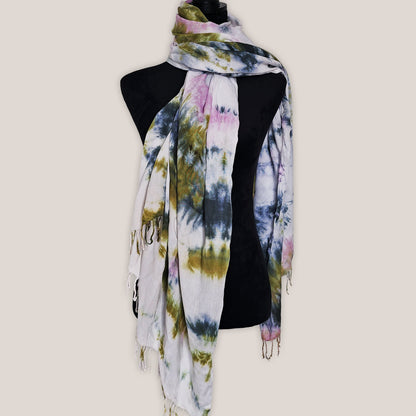 Colorful tie-dye scarf on a mannequin against a plain background