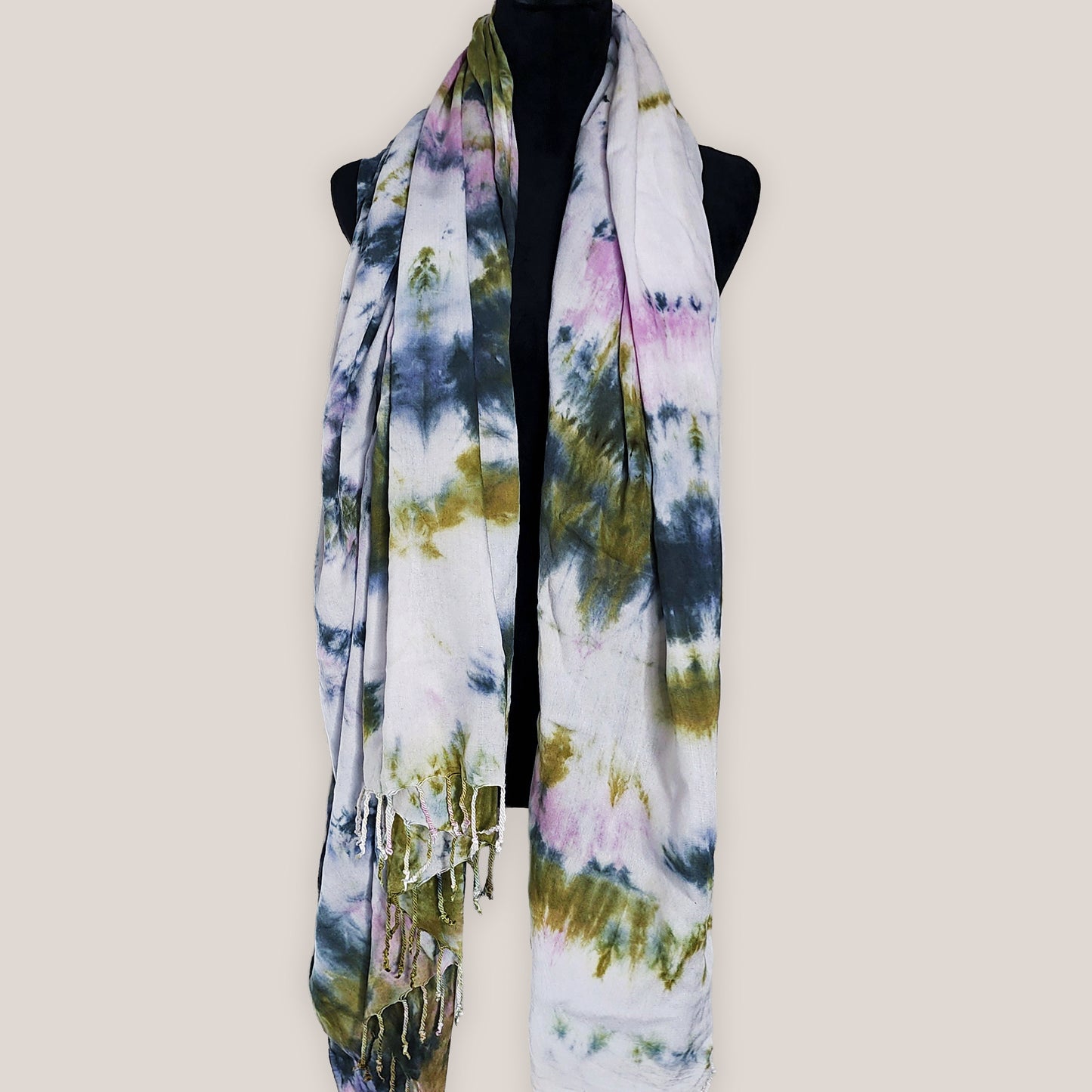 Multicolored scarf on a mannequin against a plain background