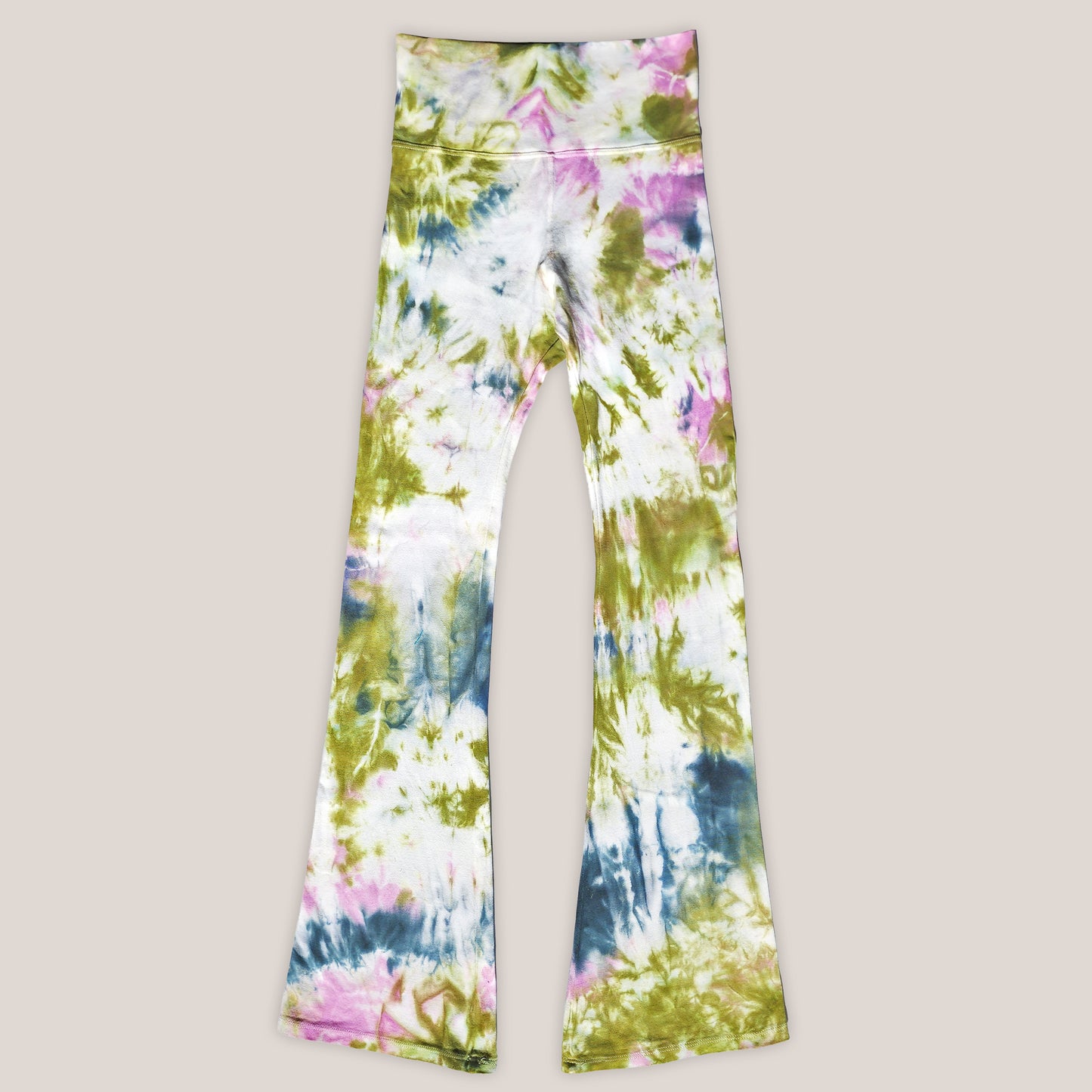 Colorful tie-dye pants on a beige background