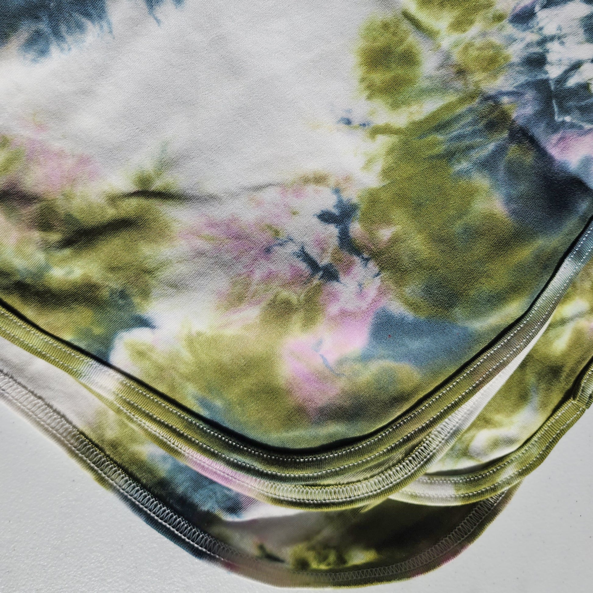 Tie-dye baby blanket upclose on a white background