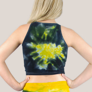 Woman wearing an Akasha Sun yellow chakra tie dye crop top in the colors black and yellow.