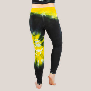 Woman wearing a pair of Akasha Sun yellow chakra tie dye leggings in size small.