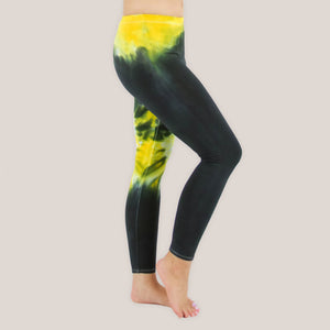 Woman wearing a pair of Akasha Sun yellow chakra tie dye leggings in size small.