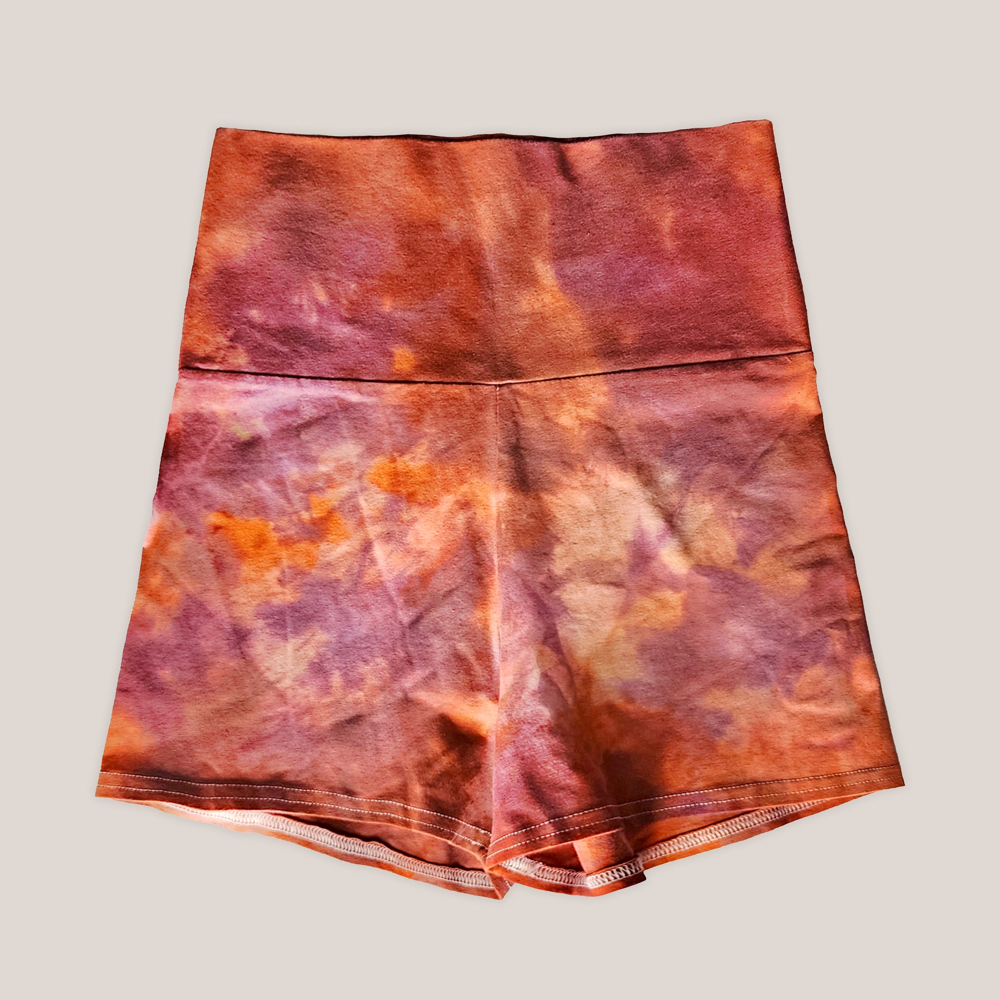 Tie-dye orange cotton patterned fabric on a beige background