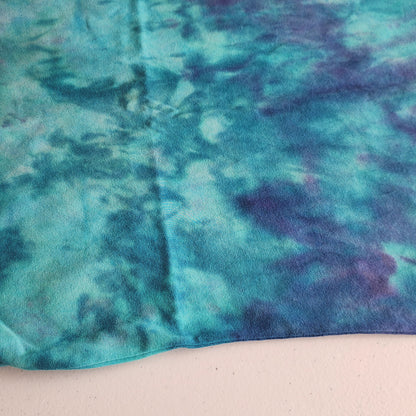 Close-up of a fabric with a tie-dye pattern in shades of blue and purple.