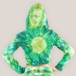 Woman wearing an Akasha Sun green tie dye crop top with a hood.