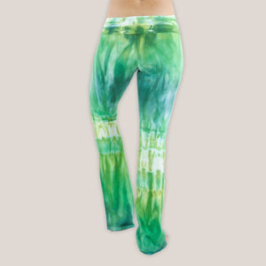 Woman wearing a pair of Akasha Sun fold over green tie dye yoga pants.