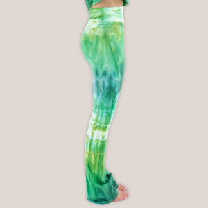 Woman wearing a pair of Akasha Sun fold over green tie dye yoga pants.