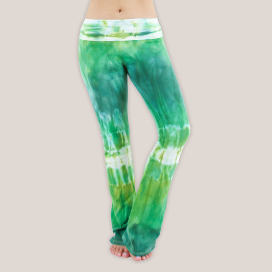 Woman wearing a pair of Akasha Sun fold over green tie dye yoga pants.