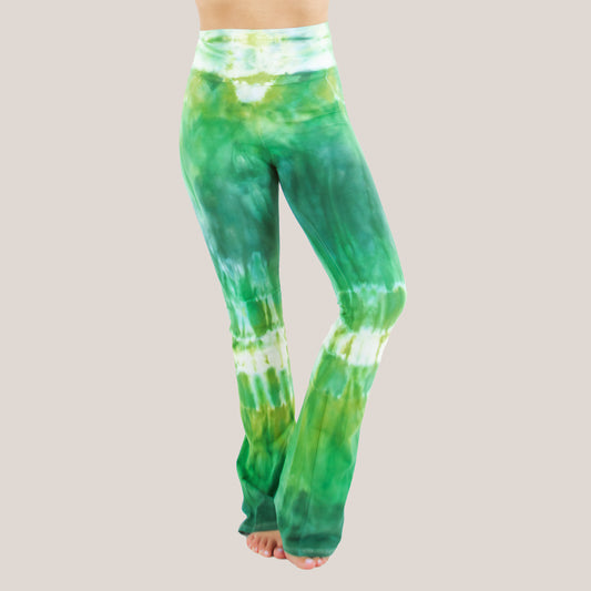 Woman wearing a pair of Akasha Sun fold over green tie dye yoga pants.
