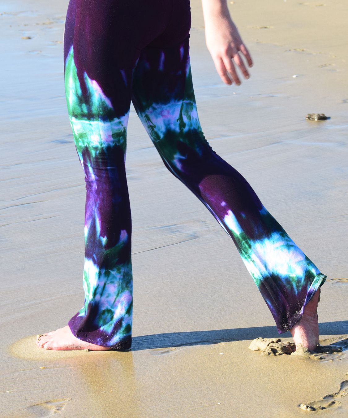 Hand-dyed purple and green yoga pants made for comfort.