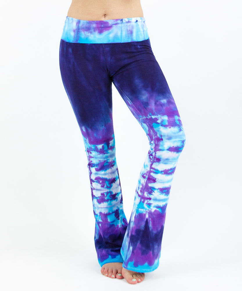 Woman wearing a pair of purple and blue tie dye sustainable yoga pants by Akasha Sun.